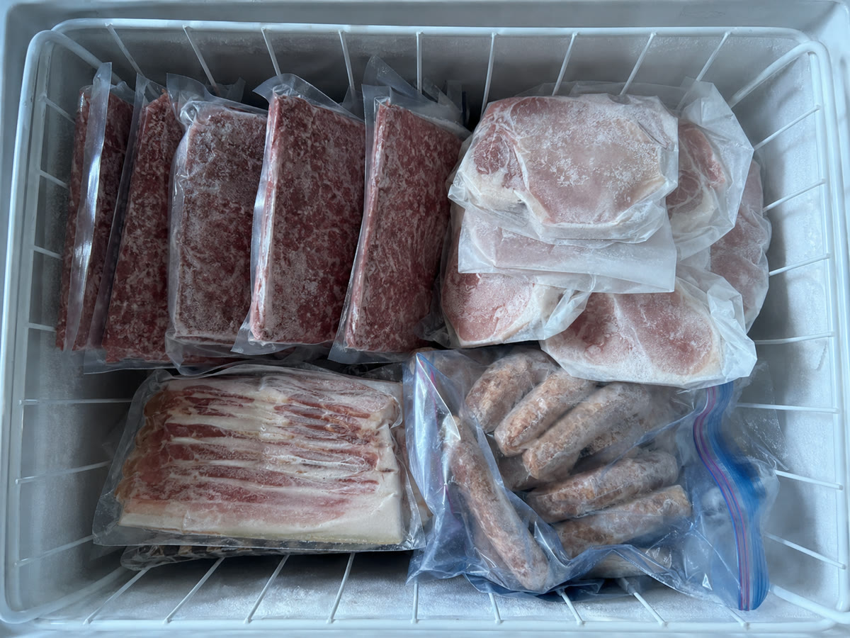 Photo of a freezer basket packed with beef and pork