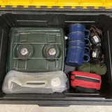 Top-down photo of camping gear inside an open tote