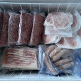 Photo of a freezer basket packed with beef and pork